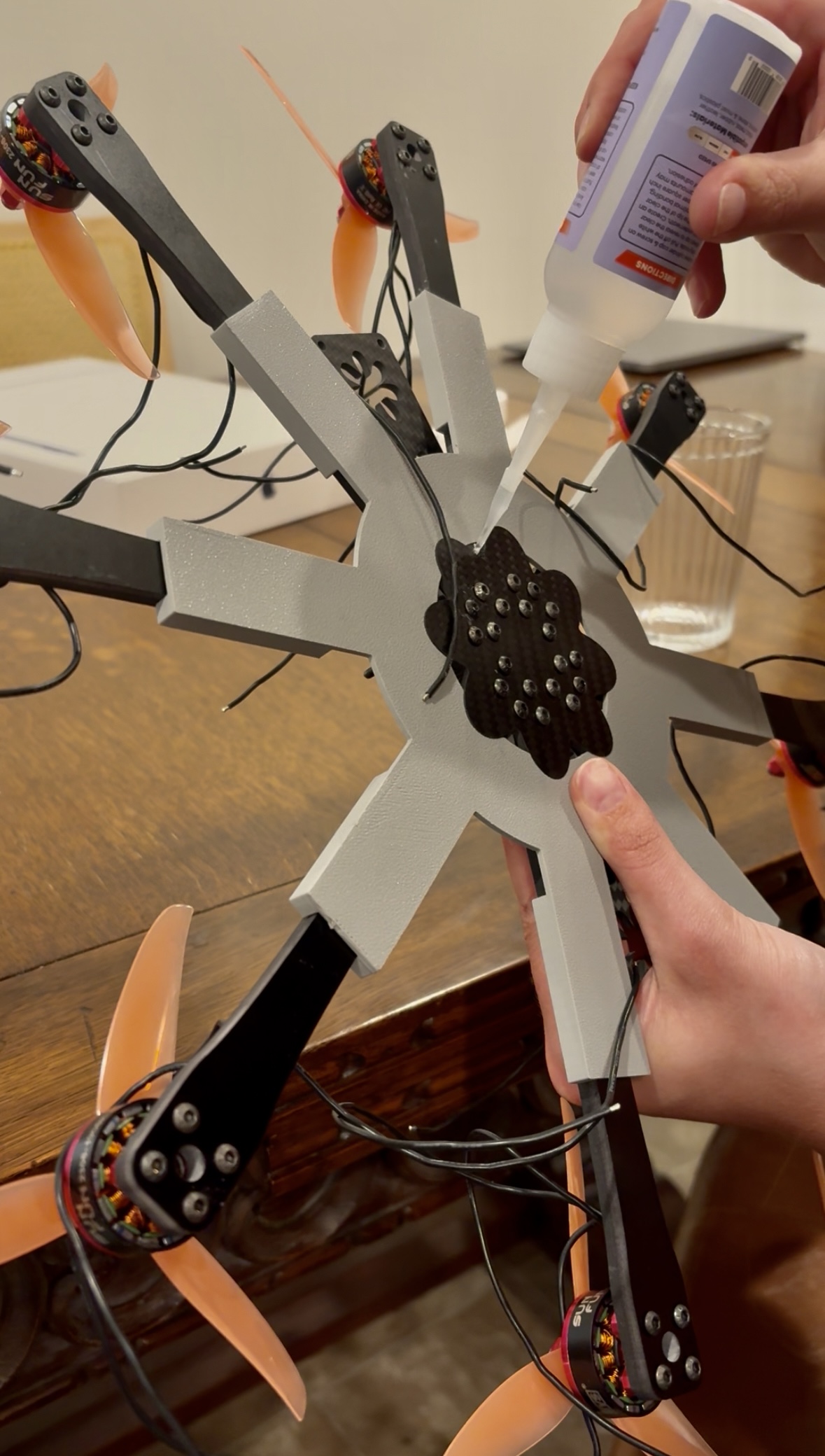 Filling the space between the arms with superglue while the drone is in the jig